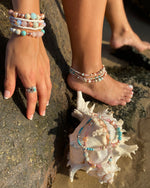 Intentional jewellery hand made in Byron Bay. Boho style natural crystal anklet featuring rose quartz, blue howlite, sea-sediment jasper, hematite, freshwater pearls and white alabaster beads strung on durable jewellers elastic.