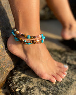 Intentional jewellery hand made in Byron Bay. Boho style natural crystal anklet featuring tiger eye, sea sediment jasper, hematite and freshwater pearl beads strung on durable jewellers elastic.