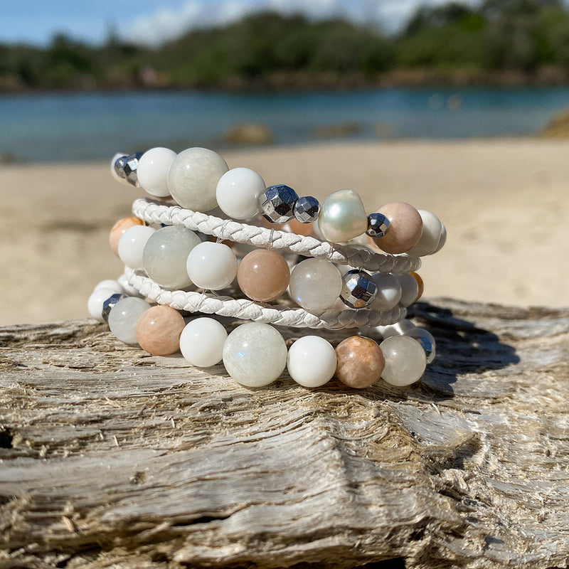 Artisan Crafted Natural Stone bracelet stack of three handmade in Byron Bay. Features natural White Alabaster, Howlite, natural sunstone, natural moonstone, freshwater pearl, Hematite, and Lava Stone beads.