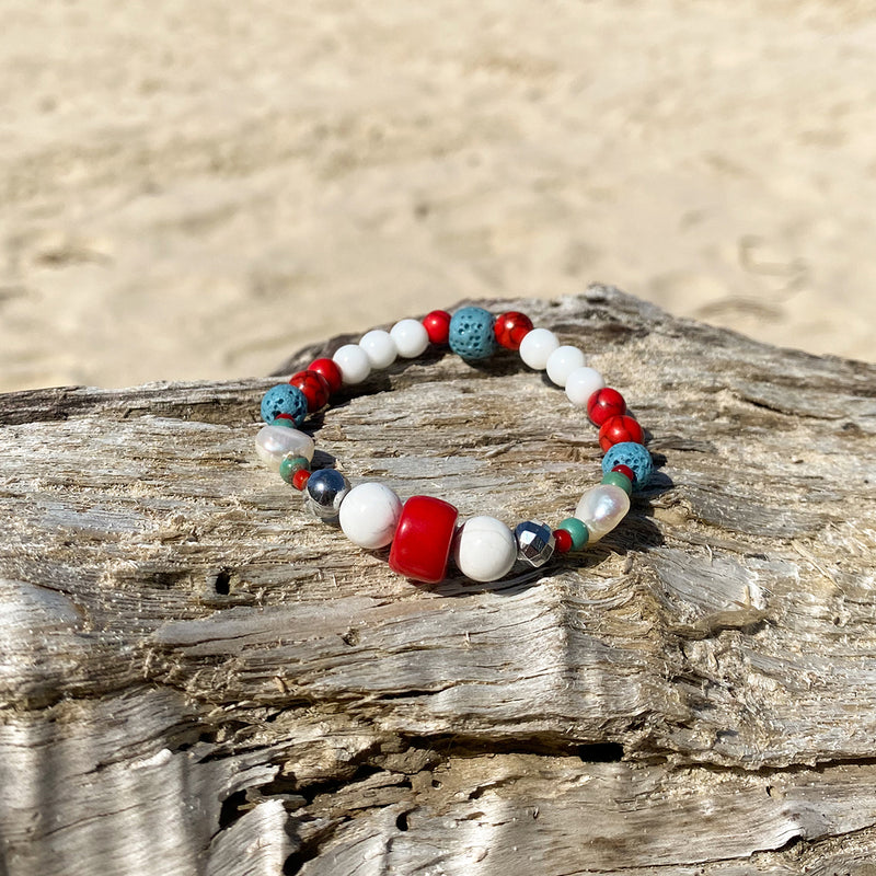 Artisan Crafted Natural Stone bracelet handmade in Byron Bay. Features Natural white and Blue Howlite, Tridacna, African Turquoise, Red Coral and Lava Stone beads.