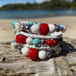 Artisan Crafted Natural Stone Leather Wrap bracelet handmade in Byron Bay. Features Natural white and Blue Howlite, Tridacna, African Turquoise, Red Coral and Lava Stone beads.