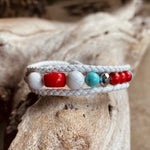 Artisan Crafted Natural Stone Leather Wrap bracelet handmade in Byron Bay. Features Natural white and Blue Howlite, Tridacna, African Turquoise, Red Coral and Lava Stone beads.
