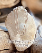 An adjustable length faux leather chord with wooden beads for wearing a crystal pendant. 