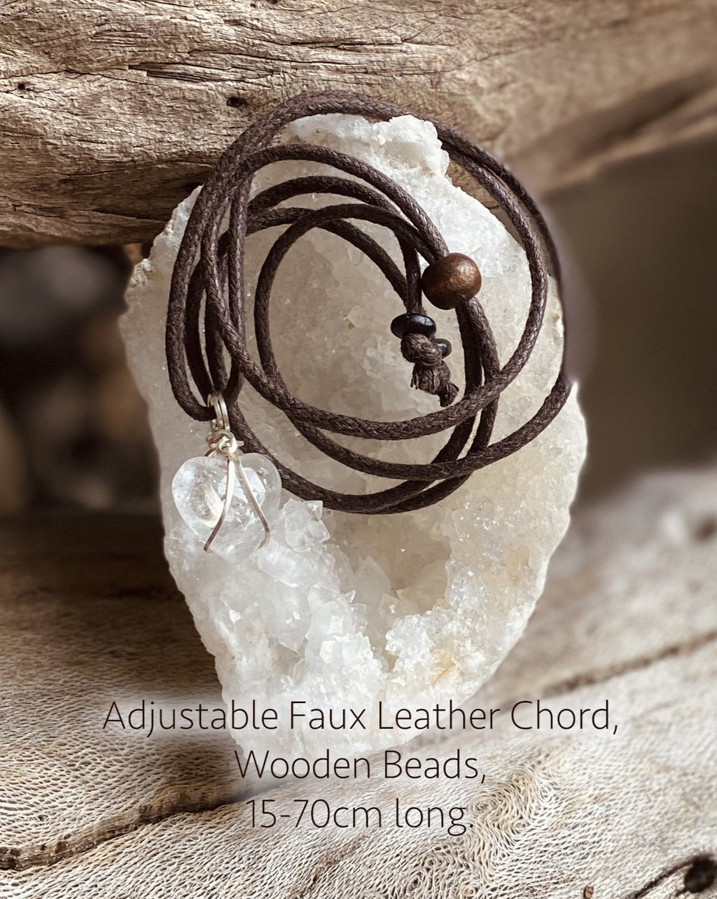 An adjustable length faux leather chord with wooden beads for wearing a crystal pendant. Brown in colour.