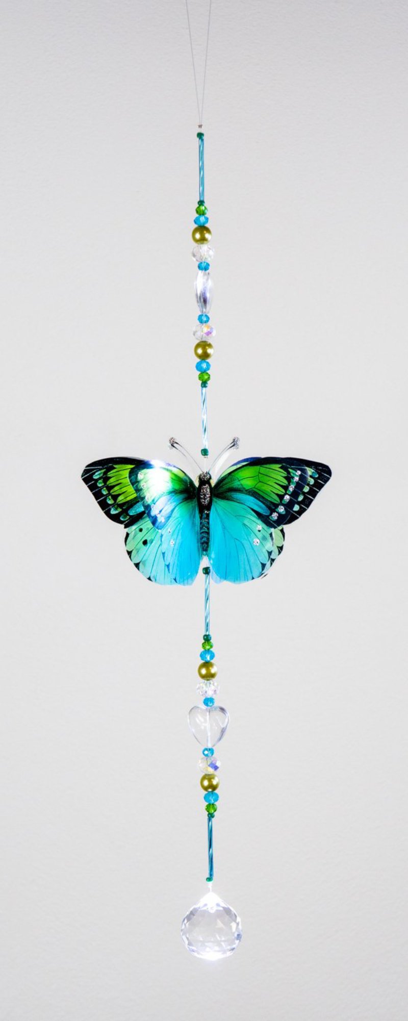 Hand made crystal suncatcher with an aqua and green butterfly motif. Made in Byron Bay, Australia.