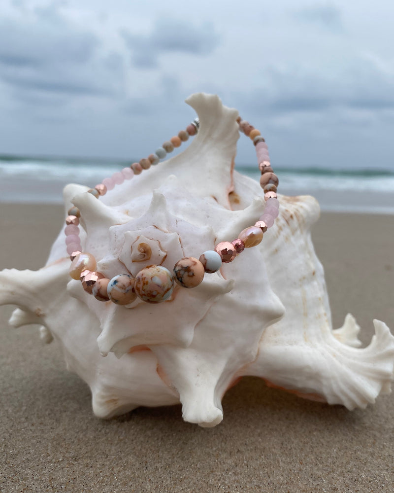 Intentional jewellery hand made in Byron Bay. Boho style natural crystal anklet featuring rose quartz, rhodochrosite, hematite and freshwater pearl beads strung on durable jewellers elastic.