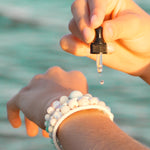 2ml Essential Oil dispenser bottle with Kylee Joy's hand made crystal and lava stone bracelets.
