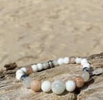 Artisan Crafted Natural Stone leather wrap bracelet handmade in Byron Bay. Features natural White Alabaster, Howlite, natural sunstone, natural moonstone, freshwater pearl, Hematite, and Lava Stone beads.